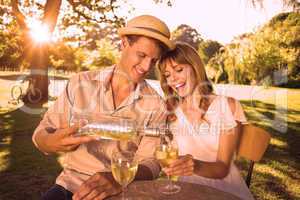 Cute couple drinking white wine together outside