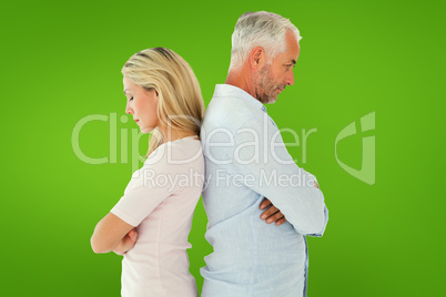 Composite image of unhappy couple not speaking to each other