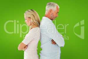 Composite image of unhappy couple not speaking to each other