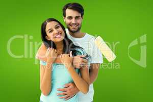 Composite image of happy young couple painting together