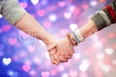 Composite image of students holding hands