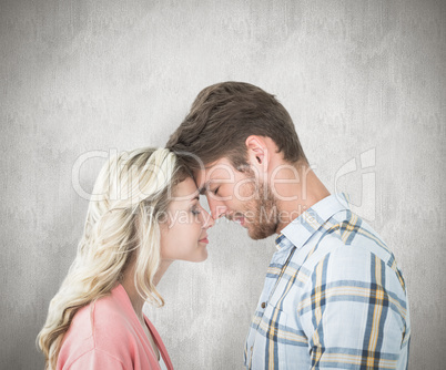 Composite image of attractive couple standing touching heads