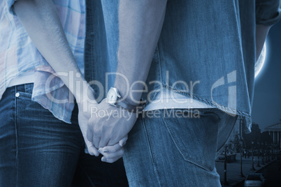 Composite image of hip young couple holding hands Composite image of hip young couple holding hands