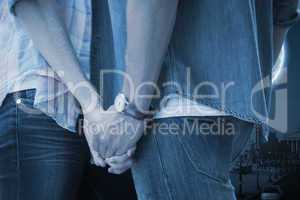 Composite image of hip young couple holding hands