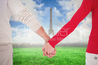 Composite image of couple holding hands rear view