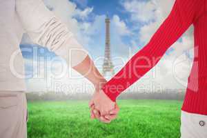 Composite image of couple holding hands rear view