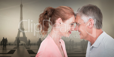 Composite image of casual couple smiling at each other