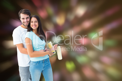 Composite image of happy young couple painting together