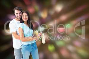Composite image of happy young couple painting together