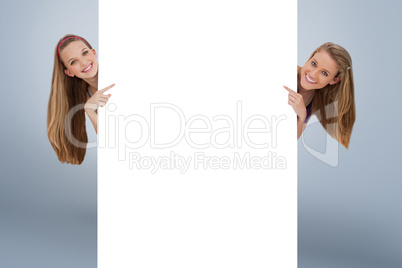 Composite image of portrait of wo long hair women back of a blan