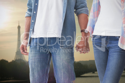 Composite image of hip young couple holding hands