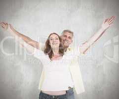 Composite image of casual couple smiling with arms raised