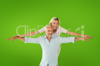 Composite image of smiling couple posing with arms out