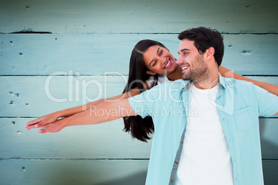 Composite image of happy casual man giving pretty girlfriend pig