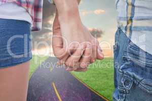 Composite image of couple in check shirts and denim holding hand