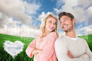 Composite image of attractive couple smiling with arms crossed