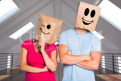 Composite image of young couple with bags over heads