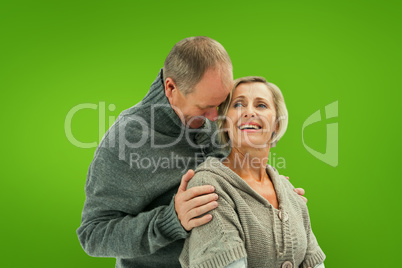 Composite image of happy mature couple in winter clothes