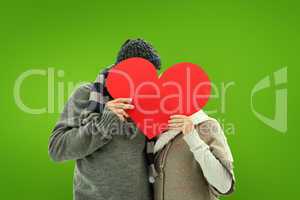 Composite image of happy mature couple in winter clothes holding