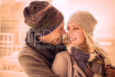 Cute couple in warm clothing smiling at each other