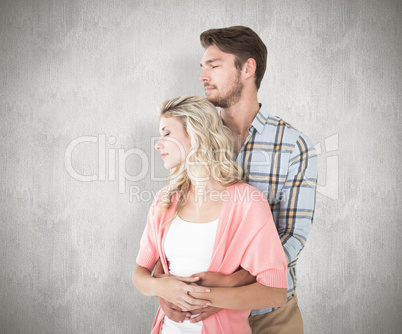 Composite image of attractive young couple embracing and smiling