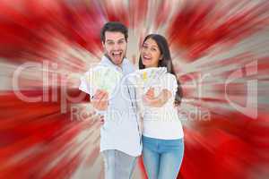 Composite image of happy couple showing their money