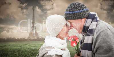 Composite image of happy mature couple in winter clothes with ro