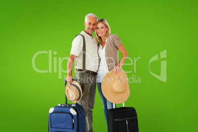 Composite image of happy couple ready to go on holiday