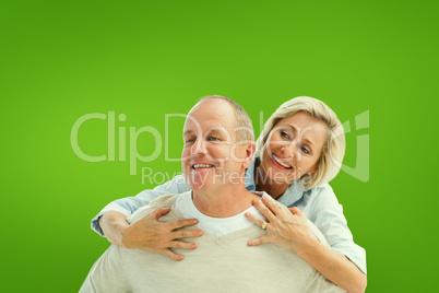 Composite image of happy mature man giving piggy back to partner