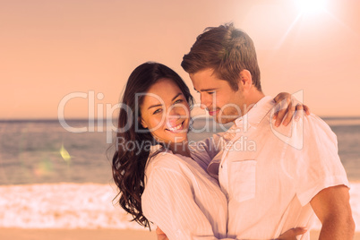 Young couple embracing and posing on the beach