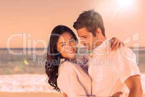 Young couple embracing and posing on the beach