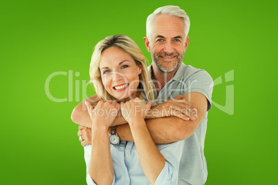 Composite image of happy couple standing and hugging