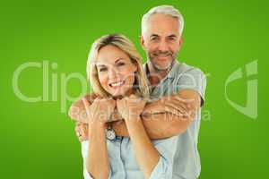 Composite image of happy couple standing and hugging