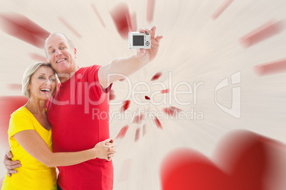 Composite image of happy mature couple taking a selfie together