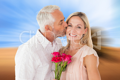 Composite image of affectionate man kissing his wife on the chee