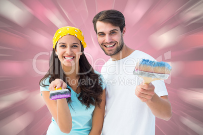 Composite image of happy young couple painting together