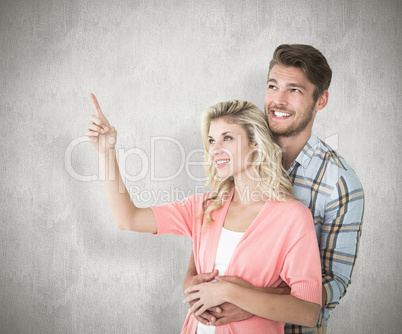 Composite image of attractive young couple embracing and looking