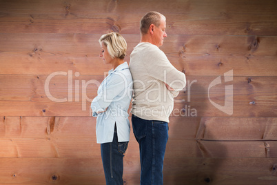 Composite image of unhappy couple not speaking to each other