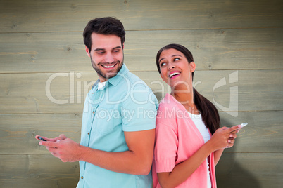 Composite image of happy couple sending text messages