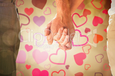 Composite image of happy senior couple holding hands Composite image of happy senior couple holding hands