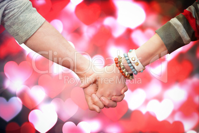 Composite image of students holding hands