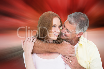 Composite image of casual couple smiling and hugging