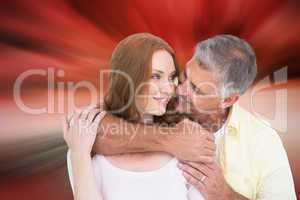 Composite image of casual couple smiling and hugging