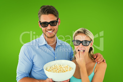 Composite image of happy young couple wearing 3d glasses eating