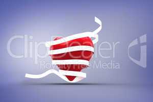 Composite image of love heart wrapped in ribbon