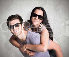 Composite image of man giving his pretty girlfriend a piggy back