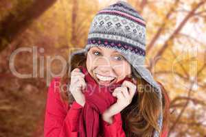 Composite image of cold redhead wearing coat and hat