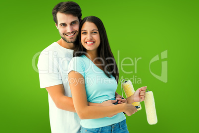 Composite image of happy young couple painting together