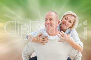 Composite image of happy mature man giving piggy back to partner