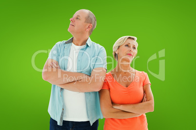 Composite image of thinking older couple with arms crossed